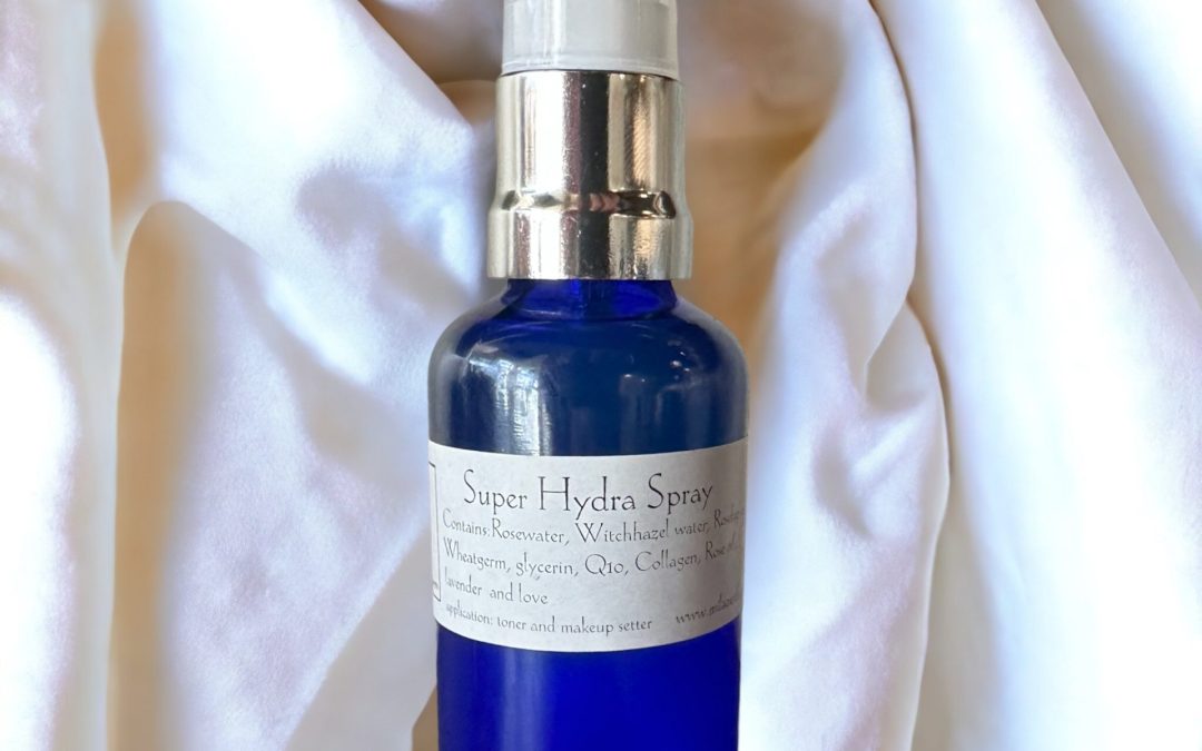 Blue bottle of Super Hydra Spray on white linen