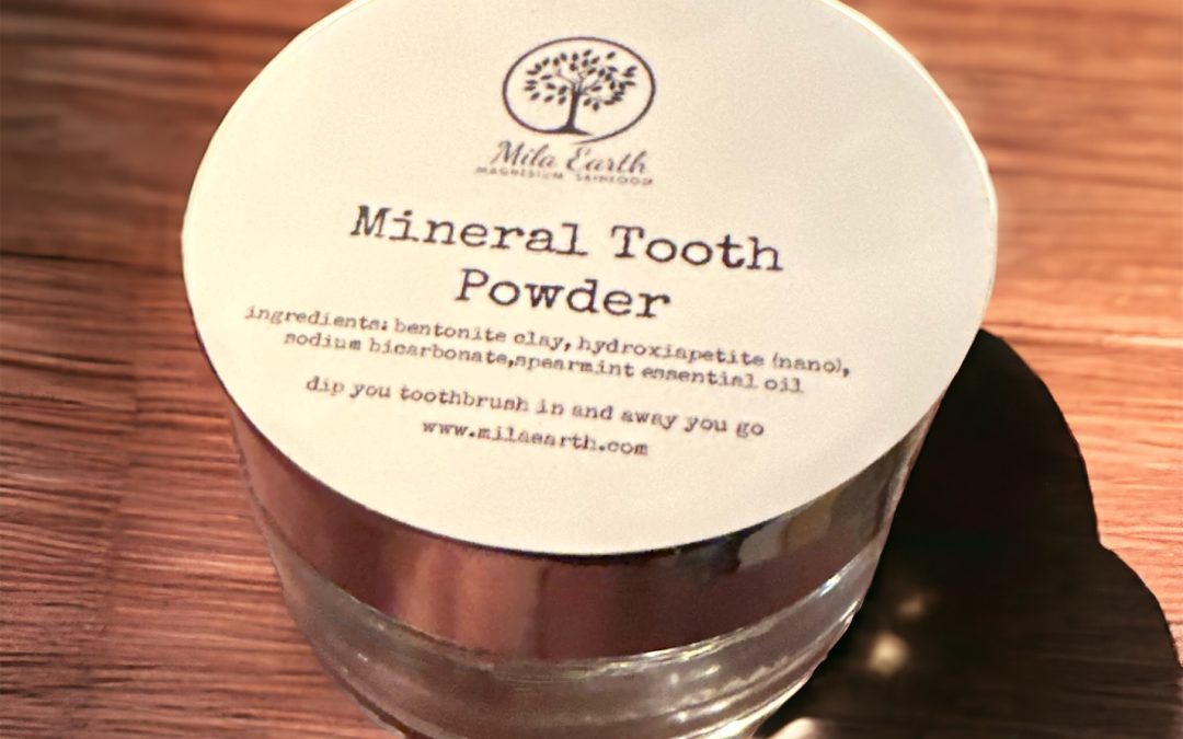Jar of Mila Earth Mineral Tooth Powder on a wooden table