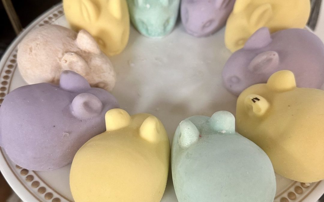 Pastel magnesium soaps shaped like skulls and hearts on a tiered stand