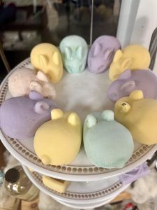 Pastel magnesium soaps shaped like skulls and hearts on a tiered stand