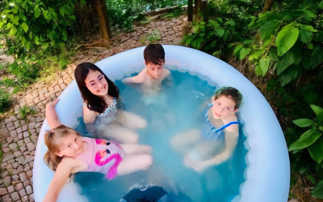 Portable magnesium: family soaking together in an inflatable outdoor tub