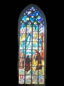 Gothic stained glass window at St. Barbara's Cathedral, glowing with colourful biblical scenes (1 of 10)